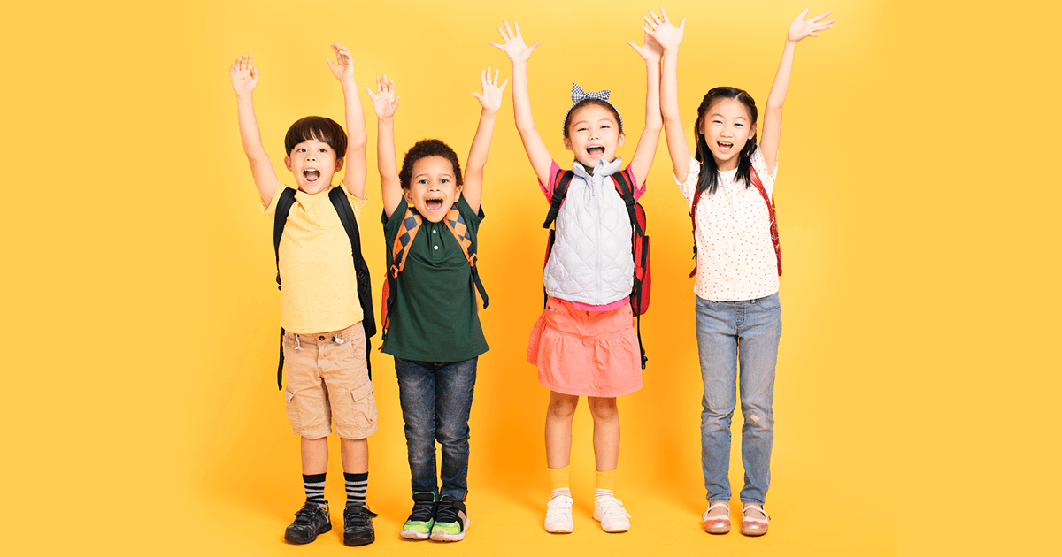 Group of happy children raising hands