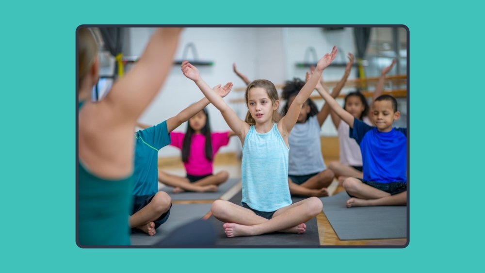 Group of elementary students practicing yoga