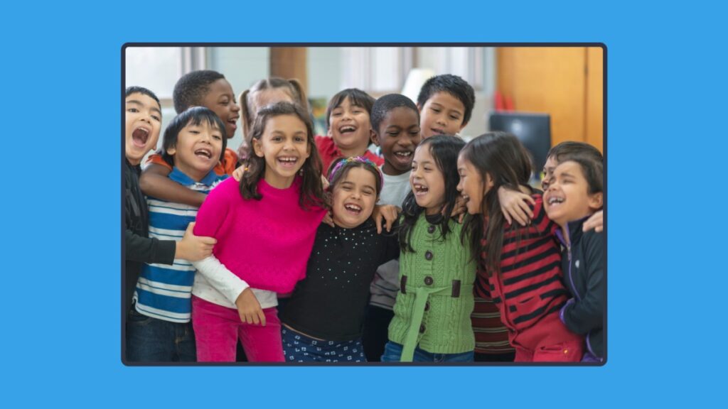a photo of a classroom of kids, smiling and laughing, lookin very happy. Photo is on a blue background