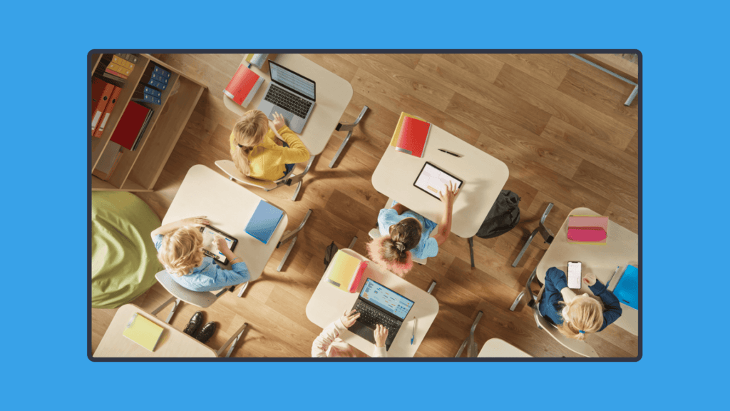 An overhead photo of students using their gadgets in the classroom