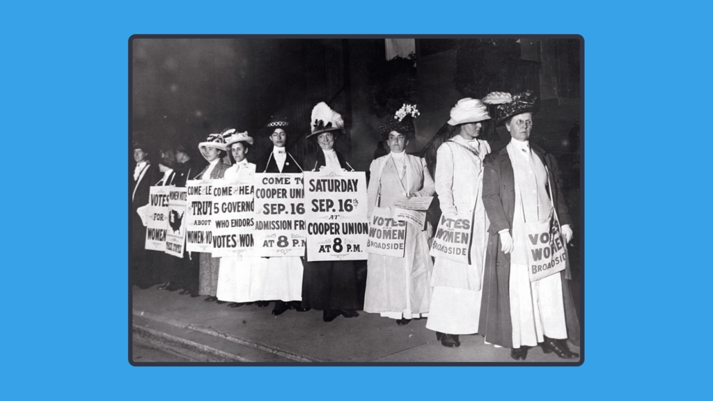 A black and white photo of women from the 20th century holding signs