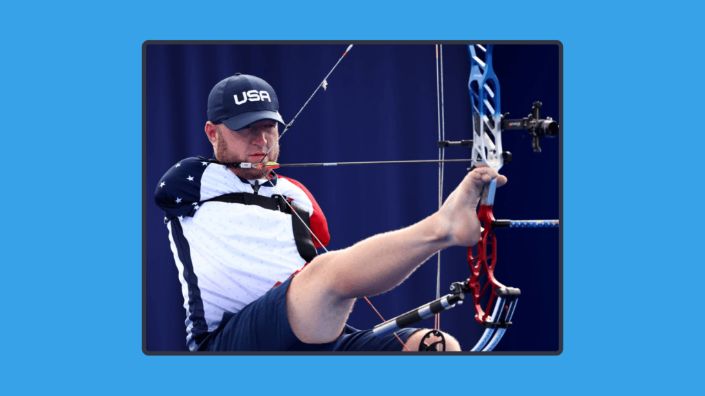 A photo of a paralympic athlete doing archery.