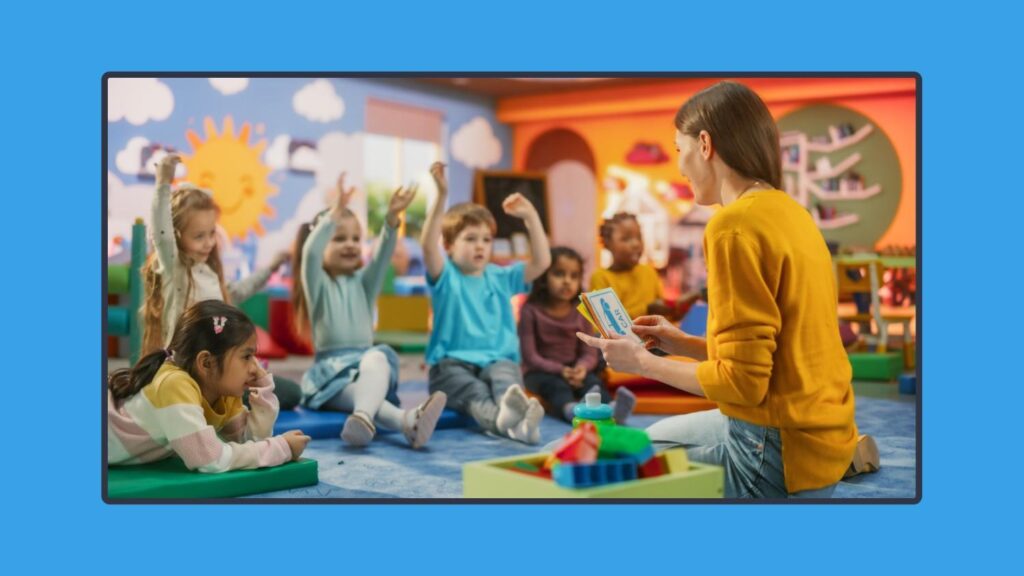 A photo of a teacher and her young students sitting on the floor.